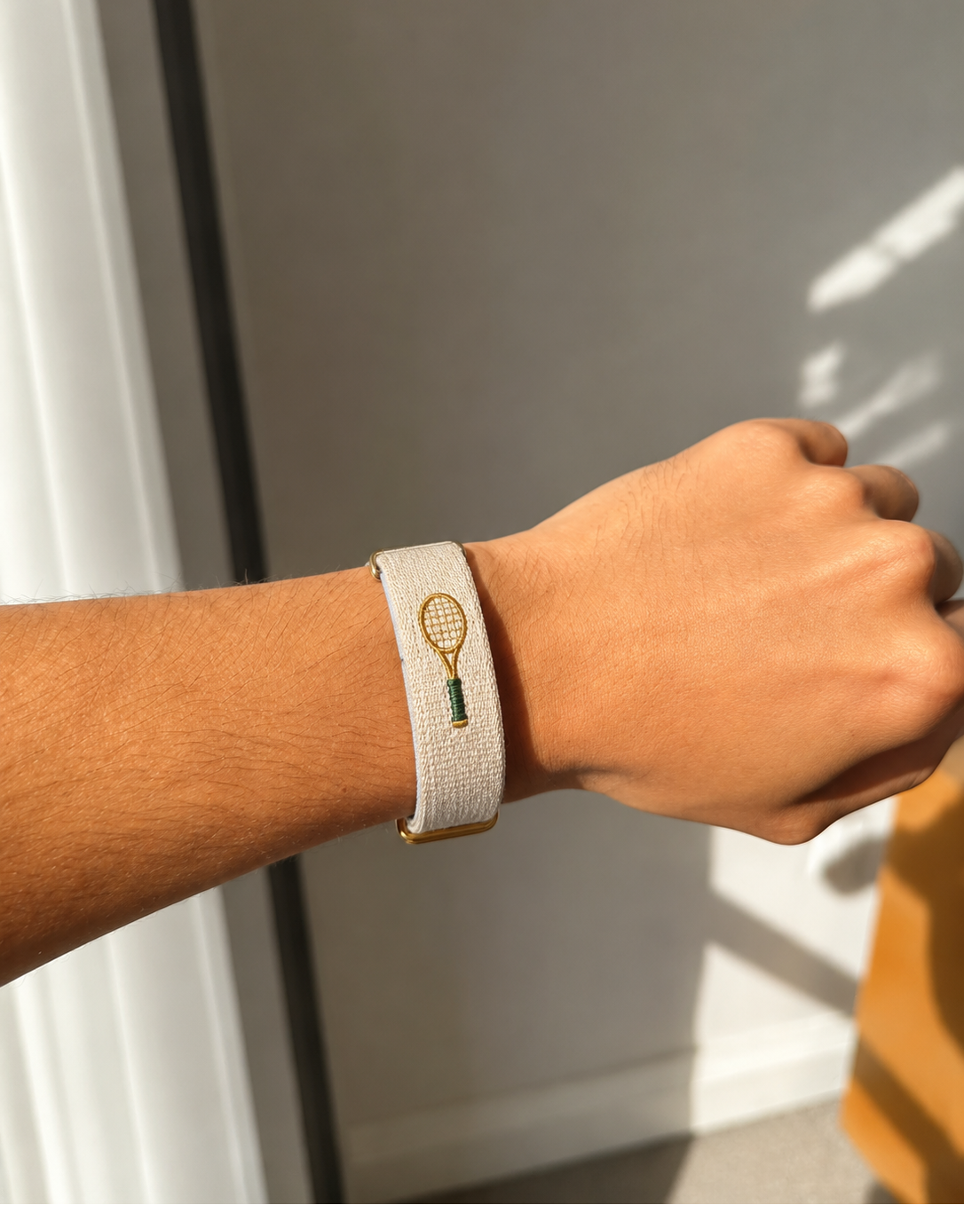 Court Side ecru woven band worn on the wrist