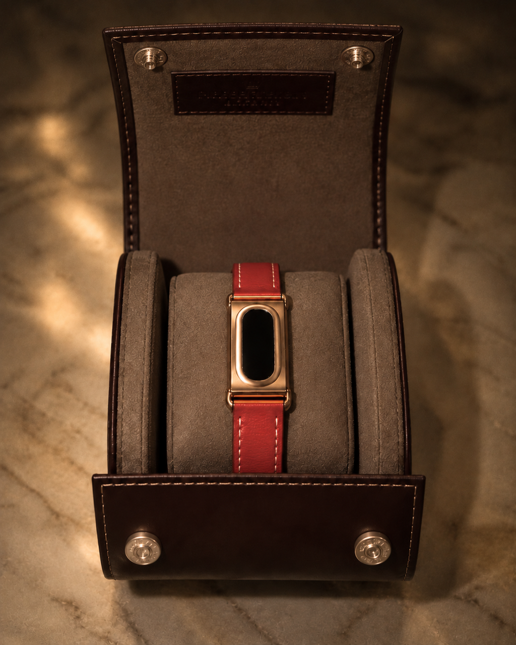 The Prenup band in Red vegan leather with a metal case, displayed in a leather watch box