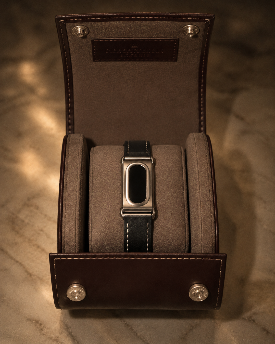 The Prenup band in Black vegan leather with a metal case, displayed in a leather watch box