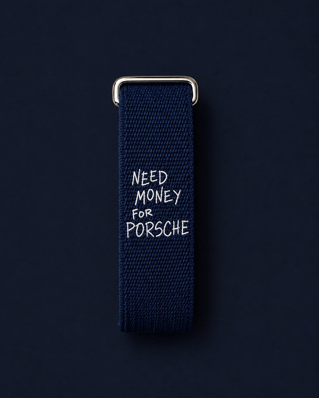 Worth the Debt band laid flat, showing the white embroidered lettering and metal buckle