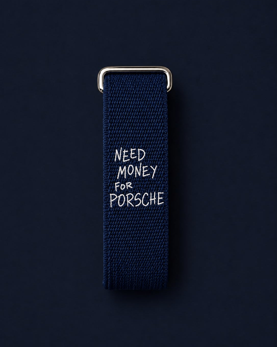 Worth the Debt band laid flat, showing the white embroidered lettering and metal buckle