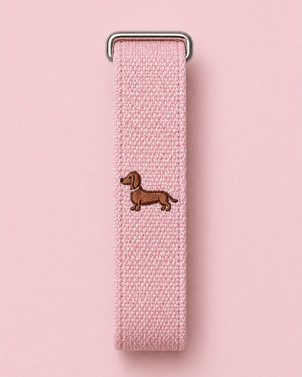 High Maintenance band laid flat, showing the embroidered dachshund and metal buckle