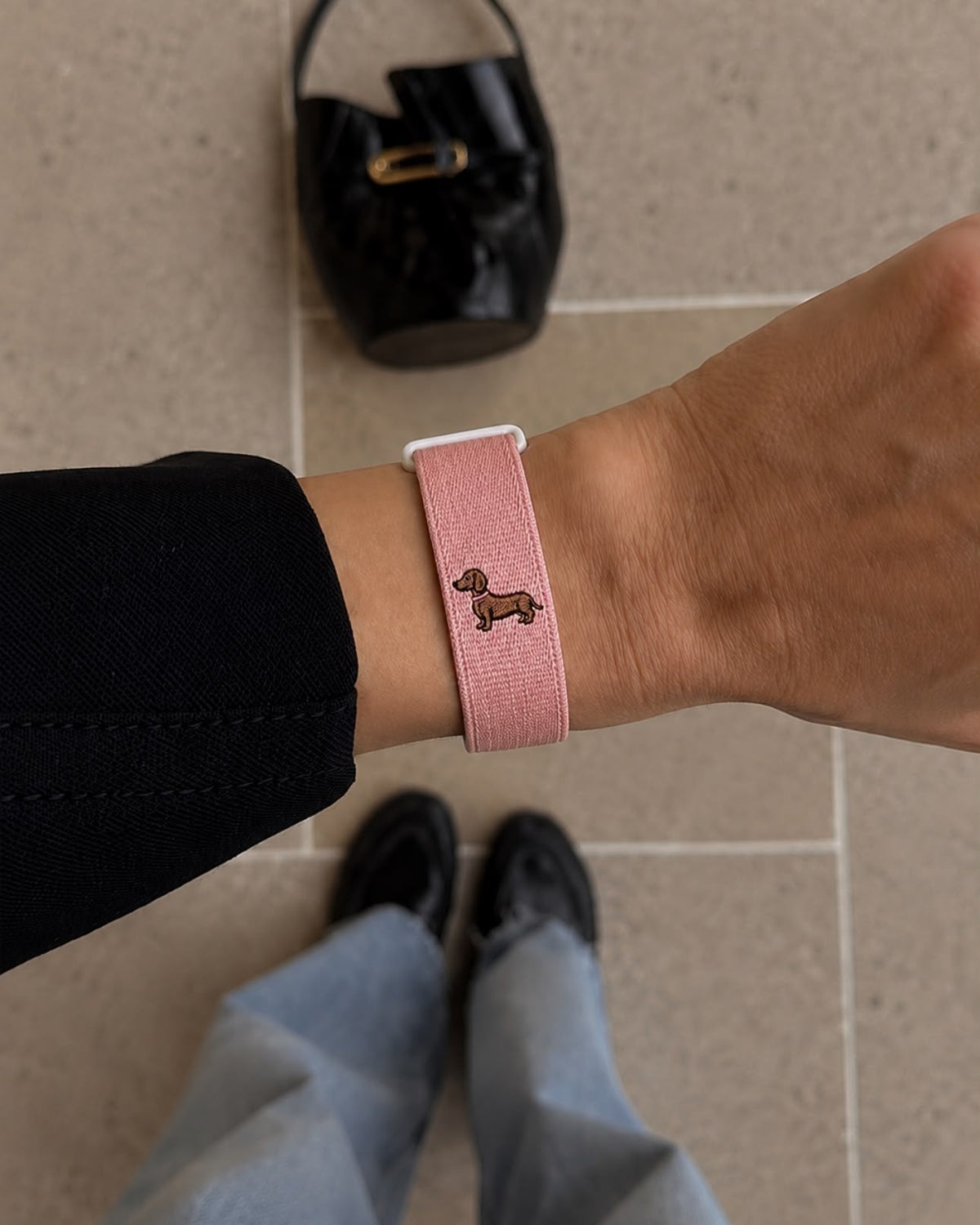 High Maintenance pink woven band worn on the wrist